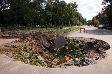 Pit on the roadway from an enemy missile