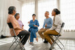 © thanmano - Group of Asian senior people sitting and listening to nurse during self help therapy group, Nursing Home