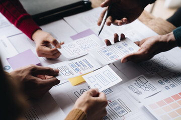 Young Asian business creative team work together, mobile application software design project. Brainstorm meeting, internet technology, smartphone web app designer, office coworker teamwork concept.