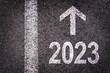 Direction 2023 written on asphalt road background, new year business goal illustration