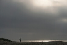Assateague National Seashore, Virginia: A Solitary Photographer Captures Sunrise On The Atlantic Ocean.
