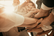 Close Up. A Group Of Young Business People Forming A Tower Out Of Their Hands