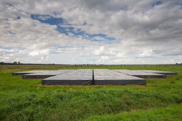 Landscape with close up of part of the largest Low-Frequency Array, LOFAR, radio telescope in the world for doing astronomical research and located between the Drenthe places Exloo and Buinen