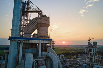 Wall Mural - Aerial view of cement factory with high concrete plant structure and tower crane at industrial production site. Manufacture and global industry concept