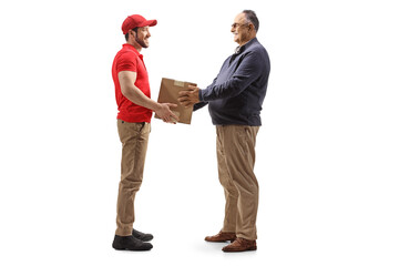 Wall Mural - Full length profile shot of a mature man taking a cardboard box from a delivery man