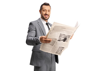 Businessman in a grey suit holding a newspaper and looking at camera