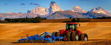 Tractor Farming Ground Harvesting Crops In Fall Autumn Teton Mountains Rugged