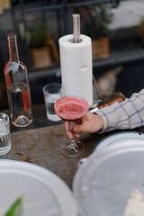 Cocktail in the hands of a man in a restaurant on the terrace, alcohol