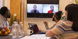 © Caia Image - Business people video conferencing with colleagues in office
