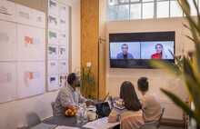 Business People Video Conferencing With Colleagues In Meeting