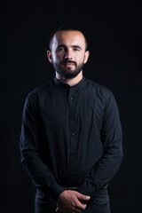 Poster - Beard man in black shirt on black background