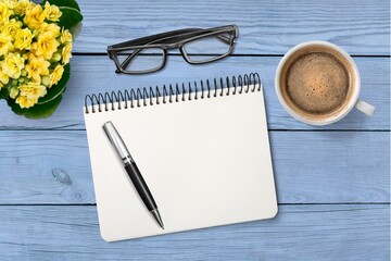 Canvas Print - Blank office notebook with pen and cup on the desk