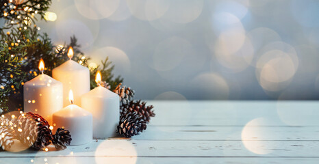 advent white candles with decor in shiny lights