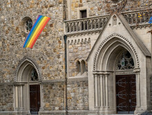 A Rainbow Colored Flag On A Church Wall In Germany. Peace And Tolerance Of Differences. Gronau, Germany