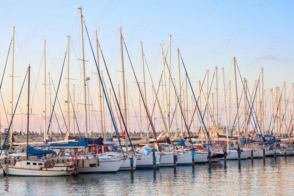View of beautiful pier with yachts at sunset
