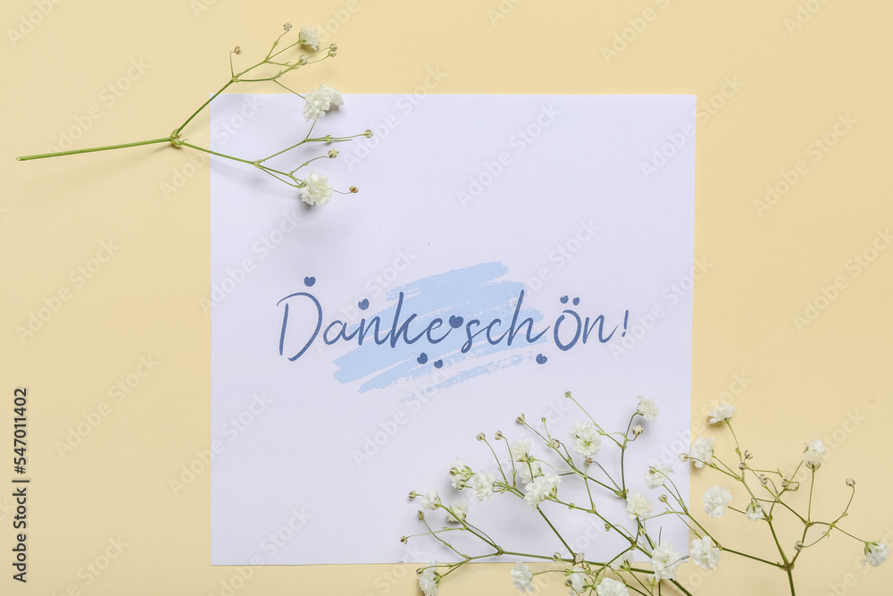 Card with text DANKE SCHON and flowers on beige background