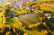 Aerial view of pond in traditional village. Czech sunny autumn countryside from above. Lisice, Czech republic, European union.