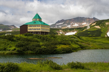 Wall Mural - View of the hotel in the mountain valley. Summer mountain landscape. Travel and tourism on the Kamchatka Peninsula. Beautiful nature of Siberia and the Russian Far East. Kamchatka Territory, Russia.