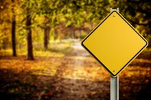 Big Yellow Road Sign At Autumn Background