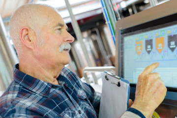 worker pressing a computer program interface