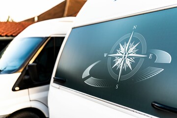 Sticker - Compass design painted on a back of microbus vehicle in the street