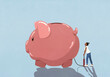 © fStop - Woman inflating piggy bank with tire pump