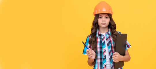 Sticker - Builder teenager girl in helmet. serious kid in construction helmet hold in clipboard and pen. Child builder in helmet horizontal poster design. Banner header, copy space.