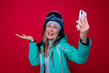 Wall Mural - Young female snowboarder takes a selfie.Active winter holidays in the mountains