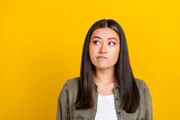 Sticker - Portrait of good mood thoughtful girl with long hairstyle dressed khaki shirt look empty space isolated on yellow color background