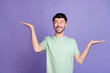 © deagreez - Photo of cheerful charismatic stylish man raise two arm interested look empty space solution isolated on purple color background