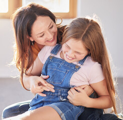 Wall Mural - Happy, love and mother bonding with her child while playing, laughing and relaxing together at their home. Happiness, smile and woman being playful with her girl kid in their modern house in Canada.