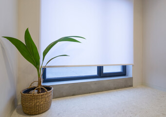 Poster - Roller shade motorized in the interior. Automatic roller blinds white color on big window. Remote control shades are above the windowsill made from concrete. Terrace is outside the window.