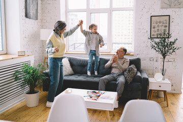 Joyful family spending time together in living room at home