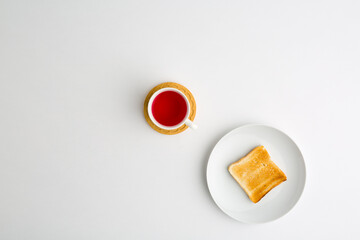 Wall Mural - Plate with toasted bread and cup of tea on white background