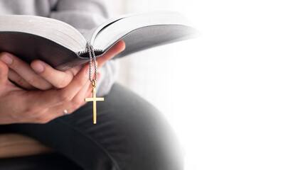 Christian praying, reading bible in his or her hands with white copyspace background. Concept of faith, Peaceful, Believe with hope and love. Spending time with God. Worship presentation.