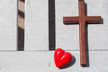 Wall Mural - Red heart, wooden Jesus cross on plank. Concept Jesus loves you, Jesus crucify himself with love. Forgiving sin, Easter time , Faith God. Christianity background, copy space.