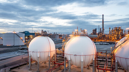 Wall Mural - Gas storage sphere tank in petrochemical industry zone with oil and gas refinery factory plant petrochemical industry and oil storage tank background, Oil refinery at twilight.