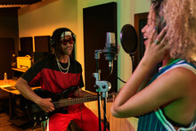 Black Man Playing Electric Guitar While Woman Singing