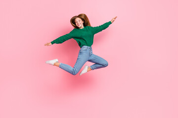 Sticker - Full length photo of sweet adorable young lady wear green sweater jumping high arms sides isolated pink color background