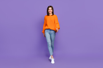 Wall Mural - Full body portrait of nice lovely cheerful lady walking toothy smile isolated on purple color background