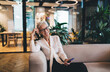© BullRun - Happy senior woman with smartphone in office