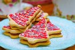 Closeup of pink decorated Christmas tree cookies served on the white plate