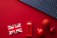 Christmas Holiday Tradition In United Kingdom And Happy Holidays Flat Lay, British Flag, London Telephone Box And Xmas Decoration On Festive Red Background As Flatlay Design, Top View