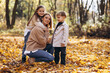 © Petro - Mother with children having fun in autumn park