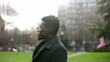 © Marco - Handsome elegant black African man standing outside at park looking up at sky