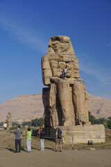 Wall Mural - Luxor, Egypt: Men work to restore one of the Colossi of Memnon (1350 BC), a massive statue of Amenhotep III, who reigned during the 13th Dynasty.