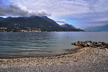 Wall Mural - Pebble beach and mountains on Lake Garda