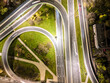 aerial view interchange ring road and motorway freeway highways and moving headlight cars transportation with over lighting the city background at night aerial view Warsaw