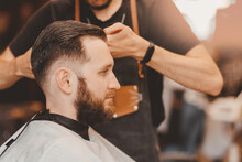 Barbershop Concept, Vintage Color. Portrait Happy Client Man In Haircut Salon, Master Does Hair Styling