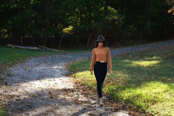 Beautiful young woman at the beach, in the park